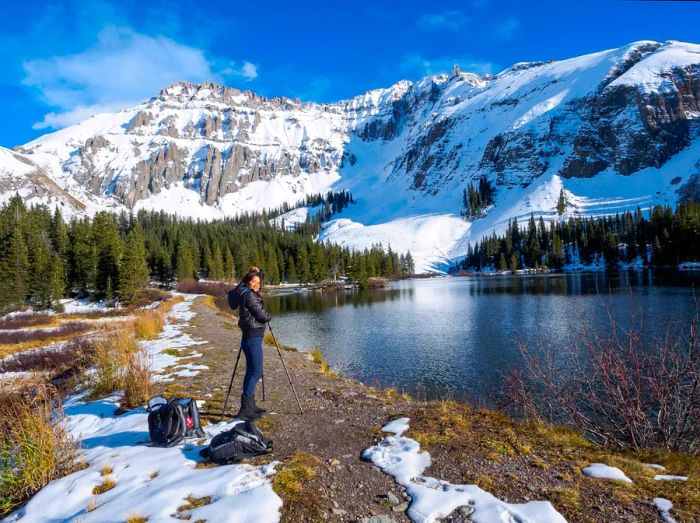 A late-winter hiker capturing stunning photography opportunities near Telluride, Colorado. YayaErnst/Getty Images