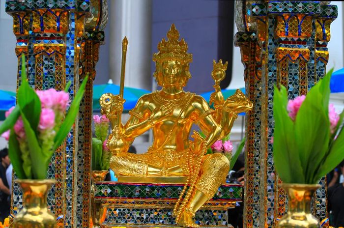 The beautifully restored golden statue of Lord Brahma (Phra Phrom), which was repaired by artisans from the Thai Fine Arts Department after the Erawan Shrine was damaged in a bombing.