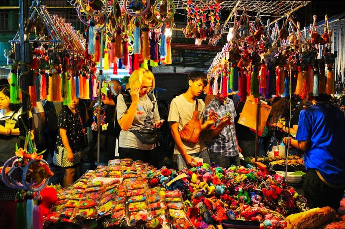 Shoppers exploring merchandise at the Saturday market Walking Street in Chiang Mai