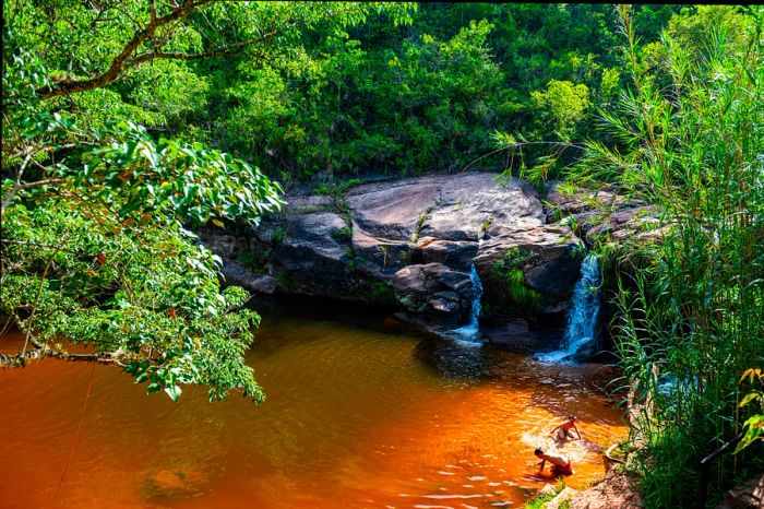 Two young boys enjoying the water at the Las Cuevas waterfalls near Samaipata, Bolivia.