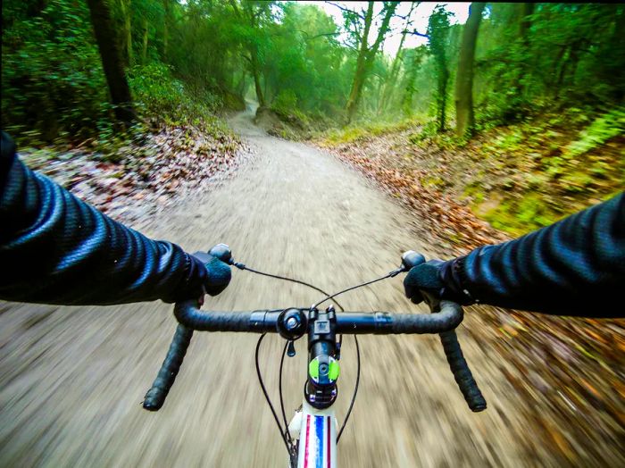 A camera on board captures a cyclist gliding through the forests of Collserola, a natural park located near Barcelona.