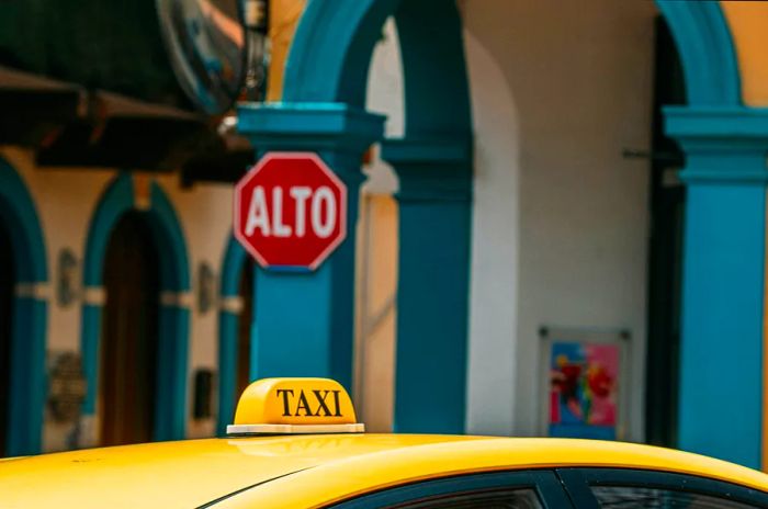 A taxi waiting outside a building in Panama City