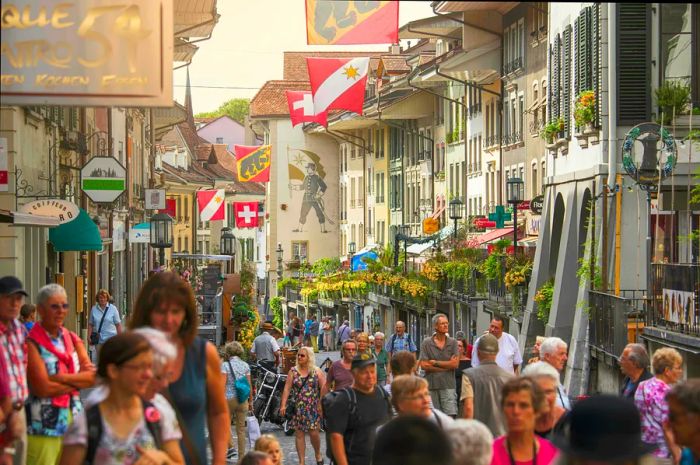 A bustling street on a summer’s day in the charming old town of Thun, a popular tourist spot in the canton of Bern.