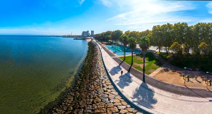 An aerial view of Barreiro at sunset, near Lisbon, with the Tagus River in the foreground. From Avenida da Praia, you can enjoy a beautiful view of Lisbon, along with the charming riverside area known as Alburrica.