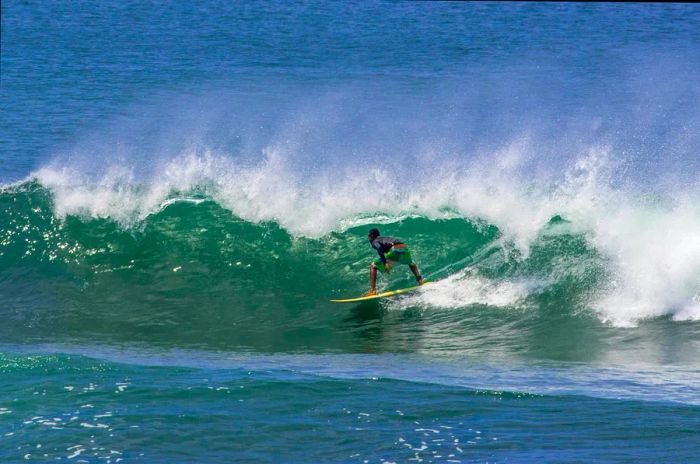 A surfer attempting to catch a big wave in Santa Catalina, Panama.