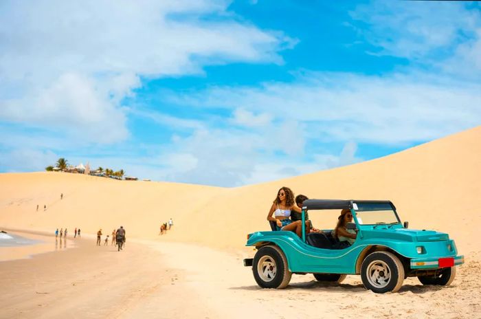 A family of four, including two teenagers, enjoys a thrilling dune buggy ride on a sunny day