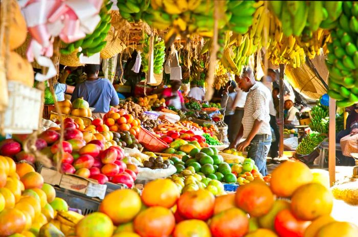 A man examines the vibrant fruits displayed at a local market in Nairobi, Kenya