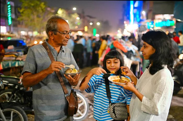 A multigenerational family enjoys various food stalls in Jodhpur, Rajasthan, India