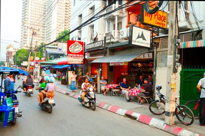 Scooters whiz down a bustling street in Chiang Mai.