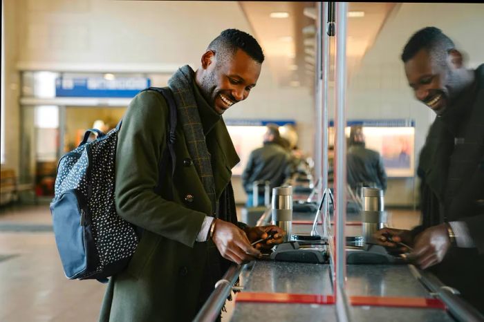 A person purchasing a train ticket