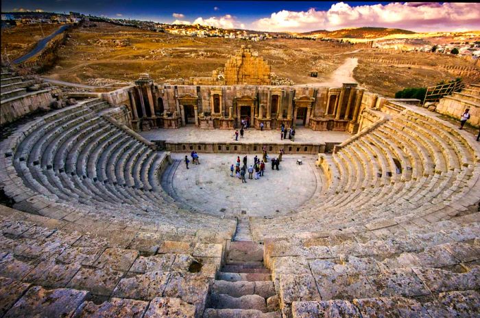 Tourists in the amphitheater, a key site among the ruins of the ancient Roman city of Jerash, Jordan