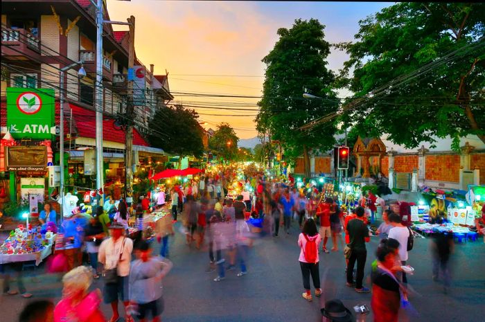 Throngs of visitors exploring the Sunday Walking Street Market in the Old Town, Night Market, Chiang Mai.