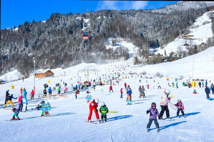 A bustling ski slope on a beginner's run in Engelberg.