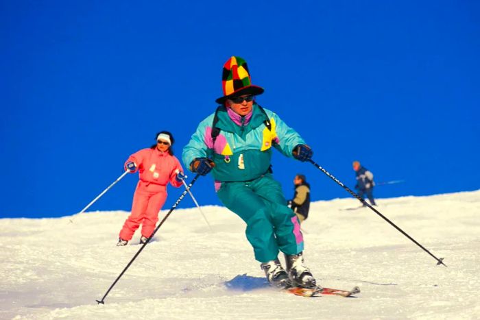 A skier in vibrant attire descends a slope near Val Thorens in the French Alps