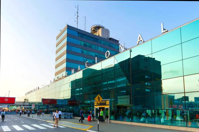 Passengers outside the glass-fronted international terminal at Lima's airport in Peru