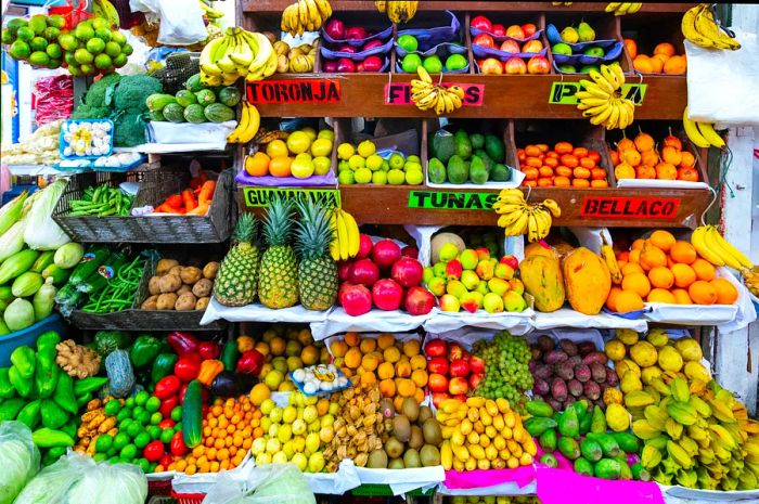 A vibrant display of fruits and vegetables at a market in Surquillo, Lima, Peru