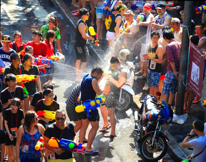 Tourists engaging in water fights during the Songkran festival in Bangkok