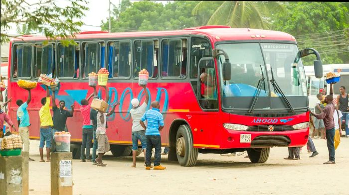 Street vendors gather around a bus in Dar es Salaam, Tanzania