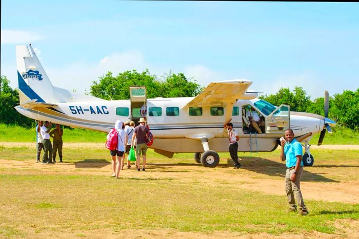 Safari tourists boarding a small plane in Tanzania