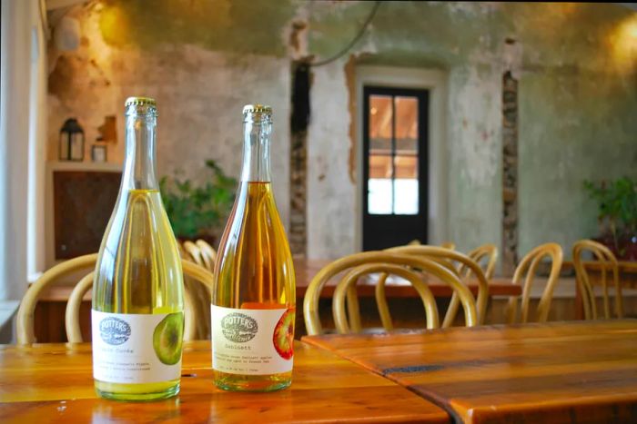 Two bottles of Potter's Craft Cider displayed on a table