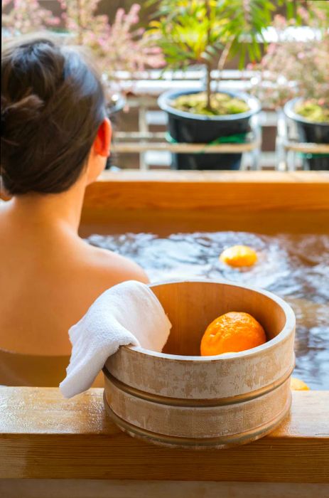 A bath bucket filled with yuzu during traditional bathing at a Japanese onsen