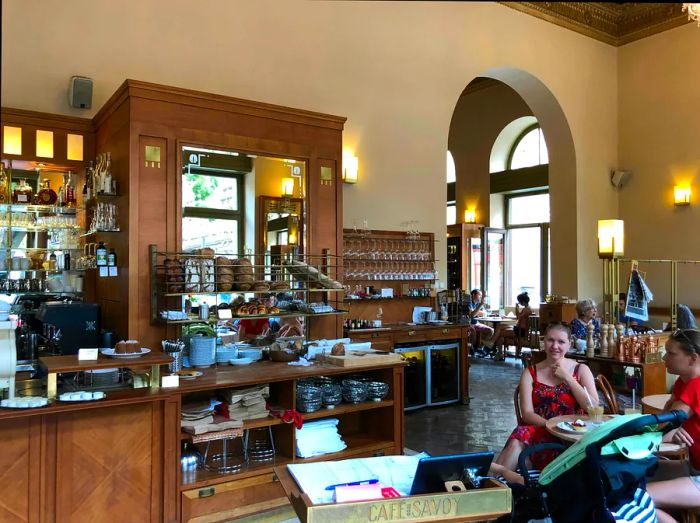 Interior of Café Savoy Prague with patrons enjoying their time at tables