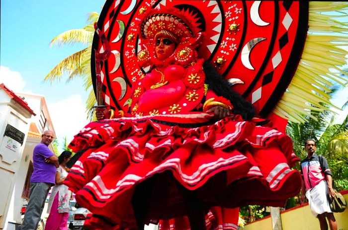 An Indian Theyyam artist performs during the Kummati Kali as part of the annual Onam festival festivities in Thrissur, Kerala, India.