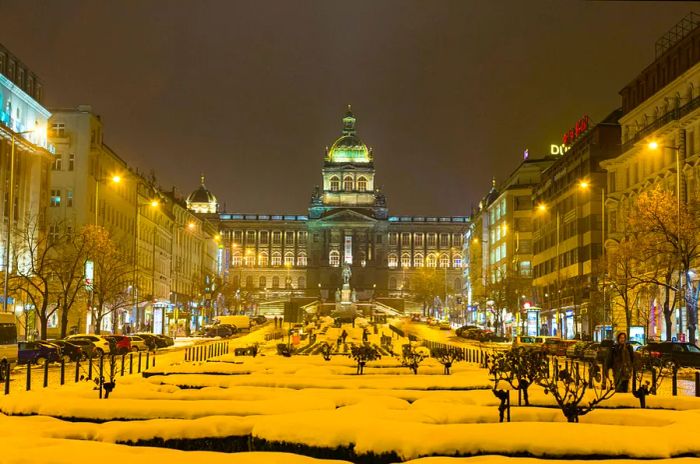 Wenceslas Square in Prague blanketed in snow, with the spires of the National Museum in view