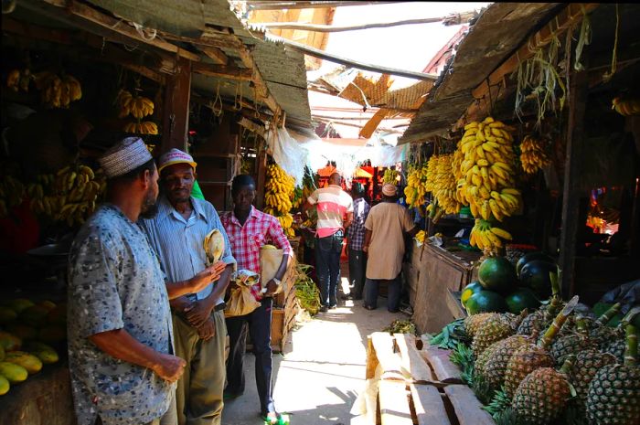 Vendors offering fresh fruits at Darajani Market in Stone Town, Zanzibar, Tanzania, Indian Ocean, East Africa