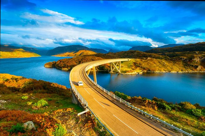 The Kylesku Bridge crossing Loch a' Chàirn Bhàin in the Scottish Highlands, a notable landmark along the North Coast 500 tourist driving route.