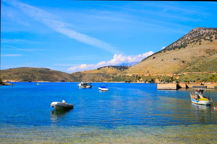 Fishing boats dotting the harbor of Porto Palermo