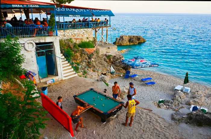 Visitors enjoy lounging on the beach, playing snooker, or savoring delicious meals at the restaurant.