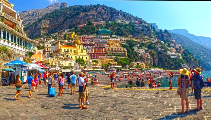 Positano is a picturesque village perched on the cliffs of Italy's Amalfi Coast. It's a popular vacation spot featuring a pebble beach and steep, winding streets adorned with shops and cafés.