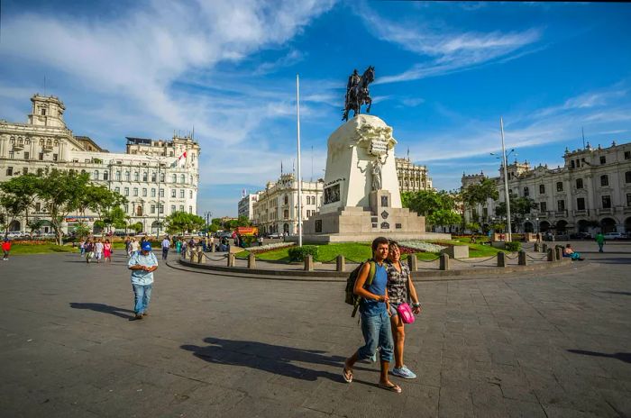 Pedestrians stroll through San Martin park in Lima, Peru.