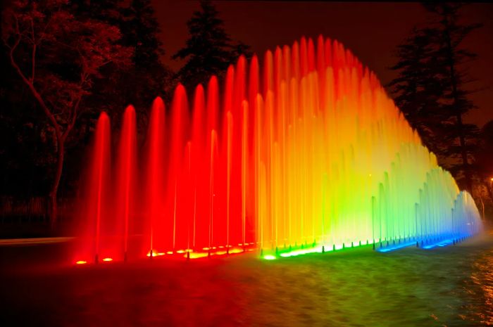 Vibrant water fountains illuminated with bright colors at night in the Magic Water Circuit Park, Lima