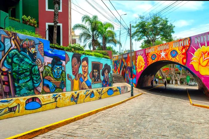 A street view featuring vibrant street art on the walls and tunnels in Lima's trendy Barranco district