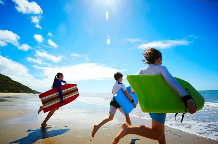 Teenagers enjoying the ocean while riding surfboards