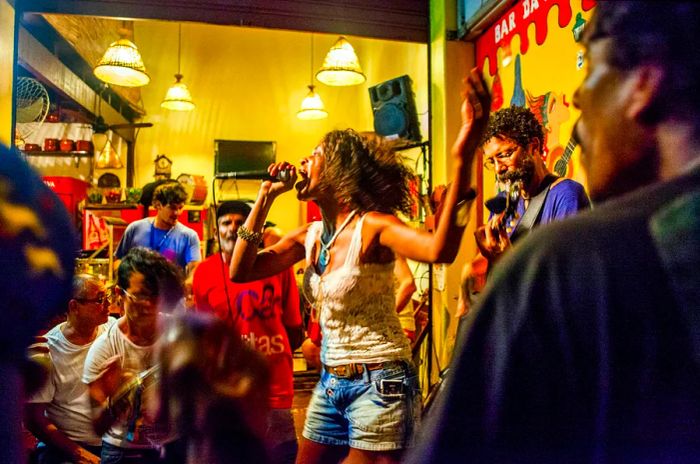 A woman performing in a lively bar in Rio de Janeiro, Brazil