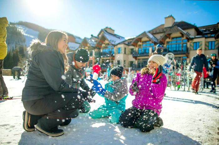 A family enjoying the snow at a resort in Vail, Colorado, USA