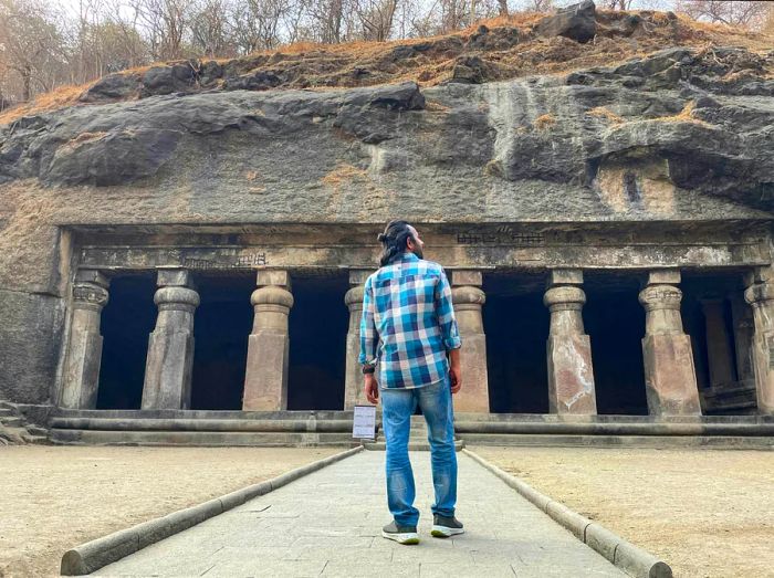 A man stands before the entrance to the Elephanta Caves in Mumbai.