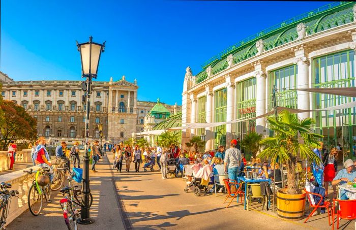 During the height of summer, visitors can be found at tables lining bustling walkways near the Hofburg Palace in Vienna.