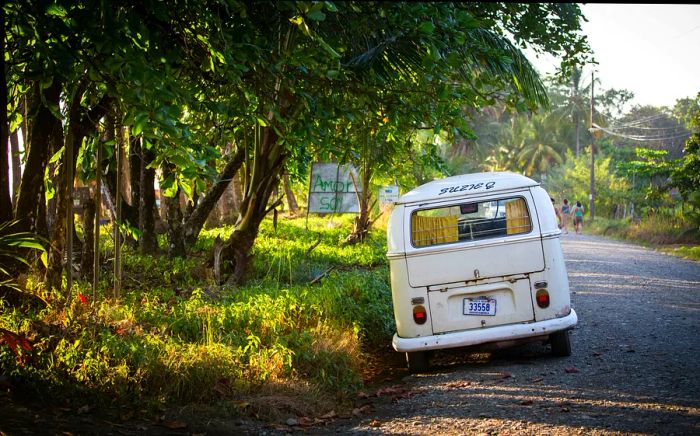 A small campervan is parked along the roadside.