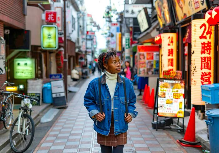 A cheerful woman strolls down a serene street in Tokyo.