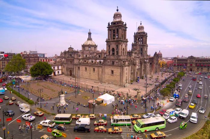 Cars and buses are stuck in traffic near Catedral Metropolitana in Mexico City.