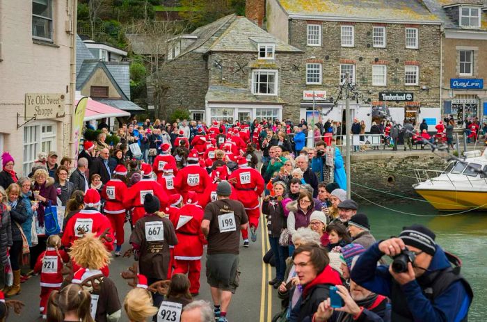 Santa and his reindeer compete in a race at the Padstow Christmas Festival, benefiting Cornwall Hospice Care.