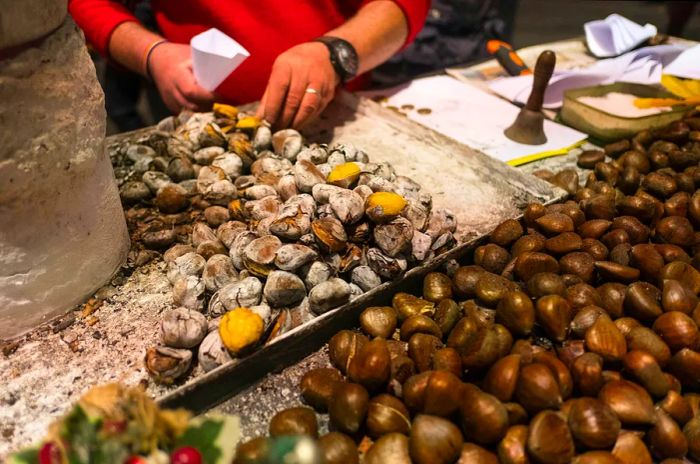 Street vendors roasting chestnuts in Seville, Spain, during the holiday season.