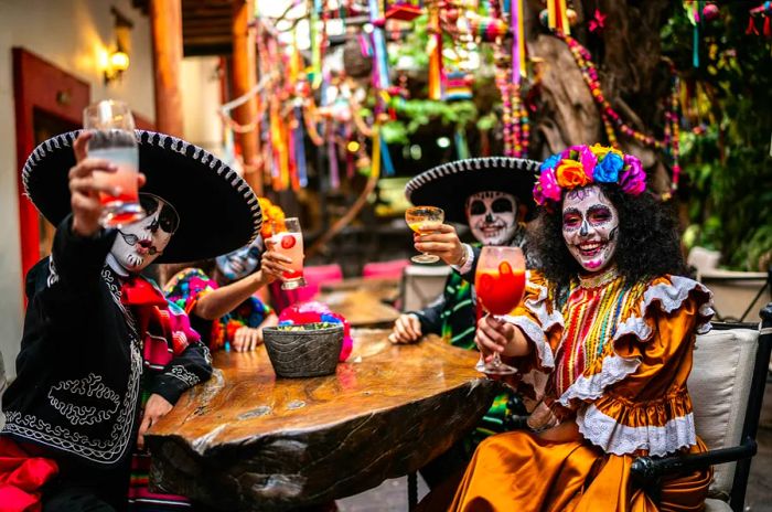 A group of friends fully adorned in makeup celebrating the Day of the Dead at a bar in Mexico