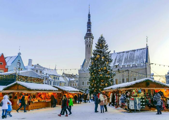 A snow-covered Christmas market graces Tallinn's Town Hall Square.