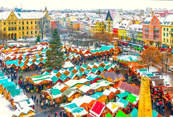 A stunning aerial view of Erfurt's historic city center, adorned with its renowned Christmas market on a snowy December afternoon.