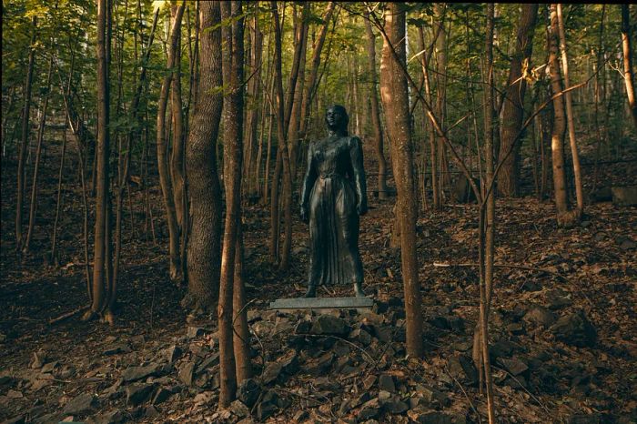 A sculpture of a figure among the trees in Ekebergparken Skulpturpark, Oslo, Norway